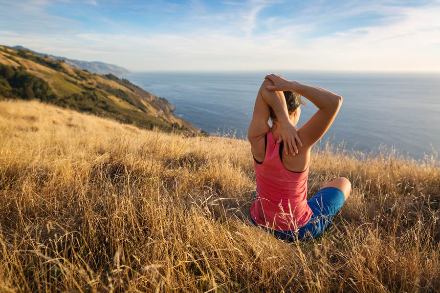 Woman Stretching and Enjoying an Ocean View