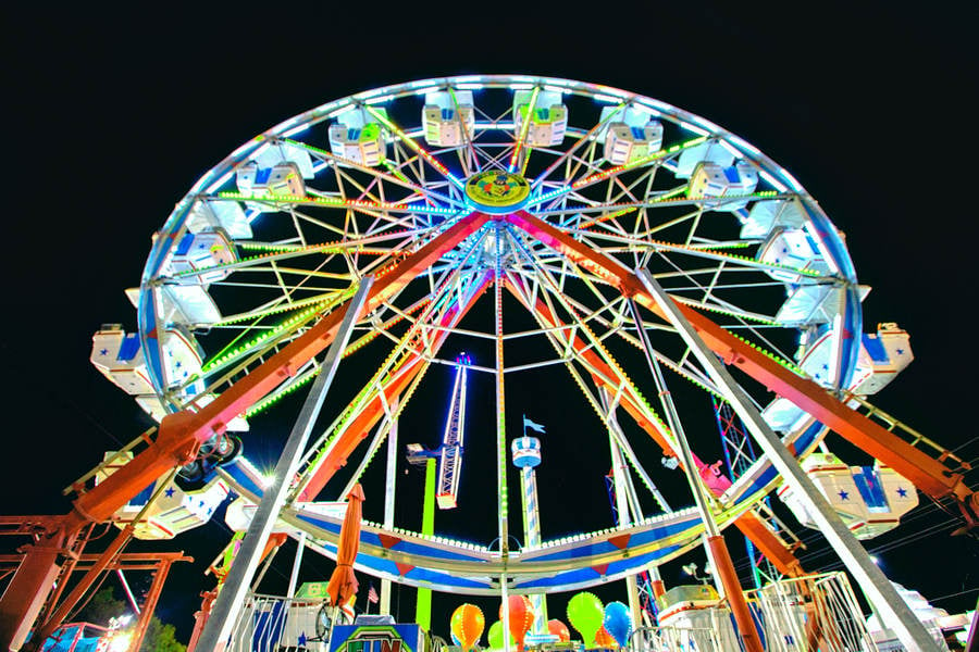 Low-Angle View of Illuminated Ferris Wheel at Night