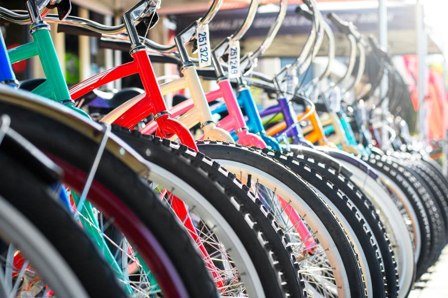 Row of Colorful Cruiser Bikes in Front of a Bike Shop