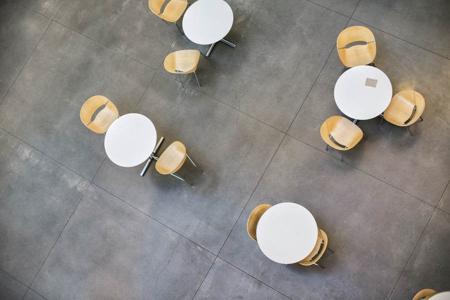 High-Angle View of Sets of Tables with Chairs on a Concrete Floor