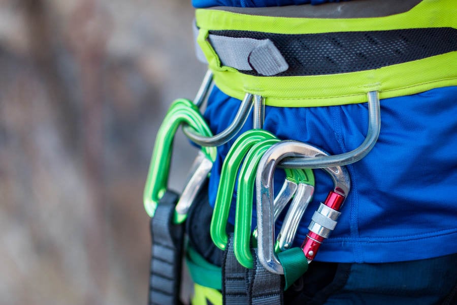 Detailed View of a Rock Climber with Climbing Gear on His Harness