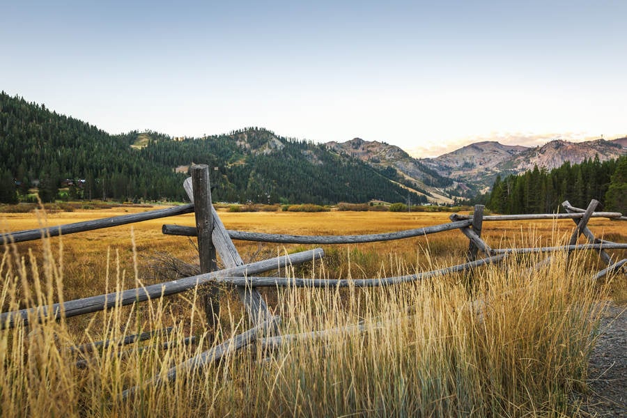 Alpine Valley Landscape with a Wooden Fence During Dawn