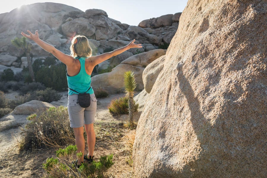 Woman Stretching Before an Outdoor Bouldering Session