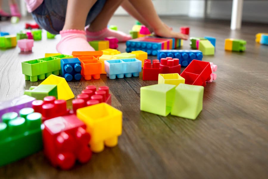 Low Angle View of a Little Girl Playing with Plastic Blocks