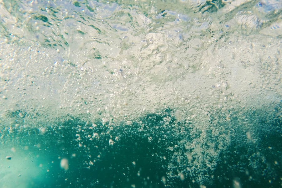Underwater View of a Shortboard and a Passing Wave