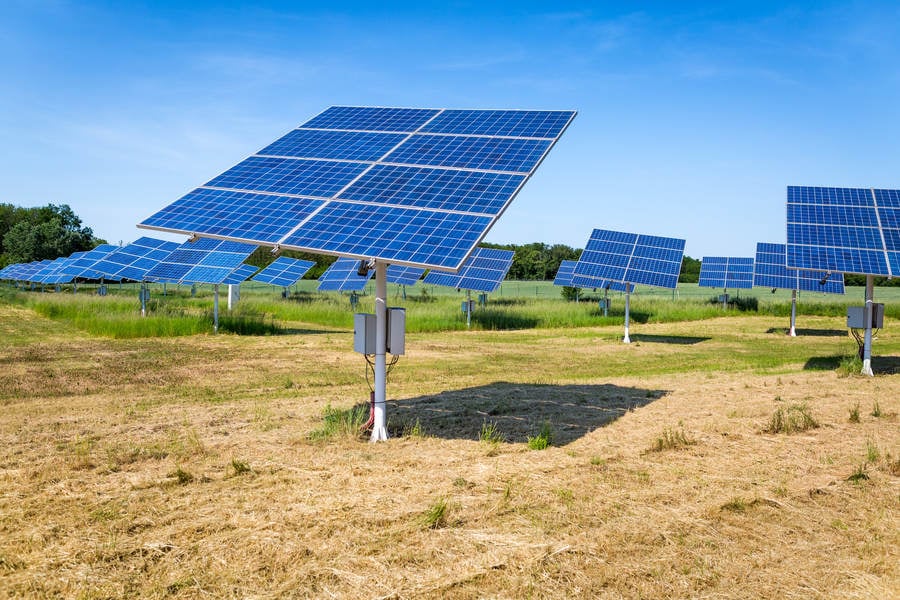 Solar Panels in a Field with the Blue Sky Above