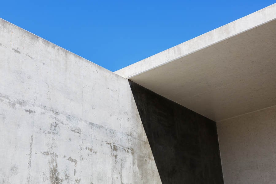 Concrete Structure Casting a Shadow with a Clear Blue Sky Behind