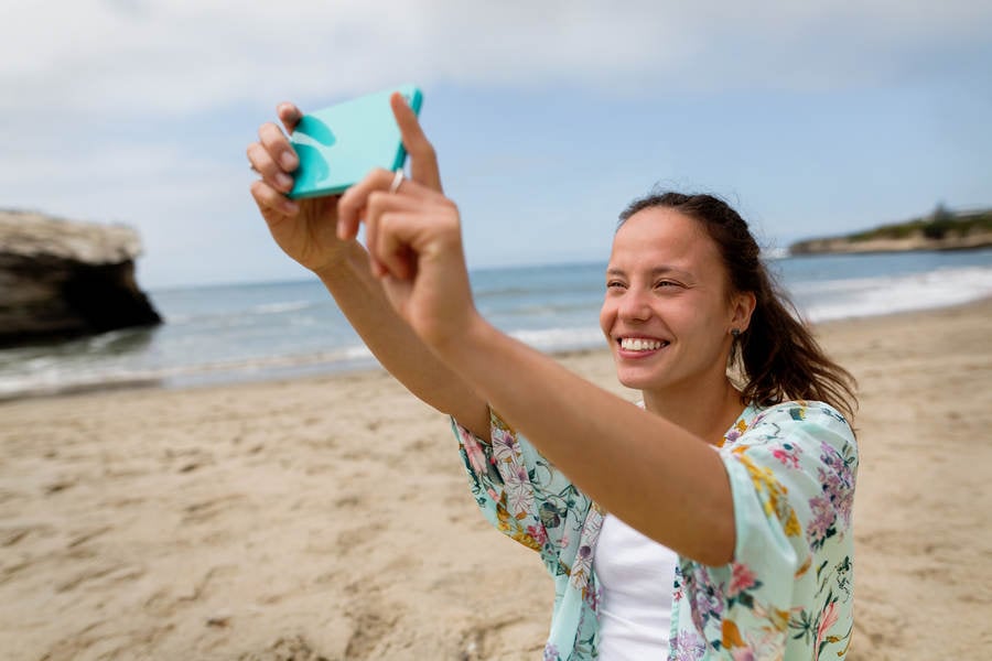 Young Woman Taking a Selfie on a Beach