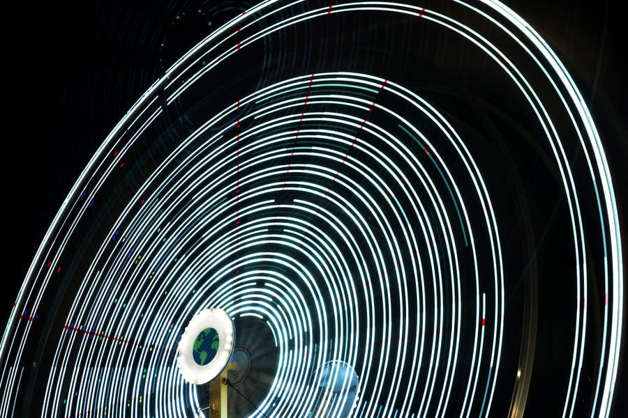 Blurred Motion of a Ferris Wheel at an Amusement Park at Night 