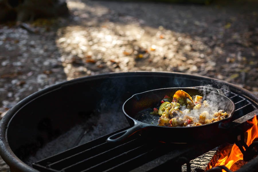 Breakfast Cooking in a Skillet on an Outdoor Fire Pit
