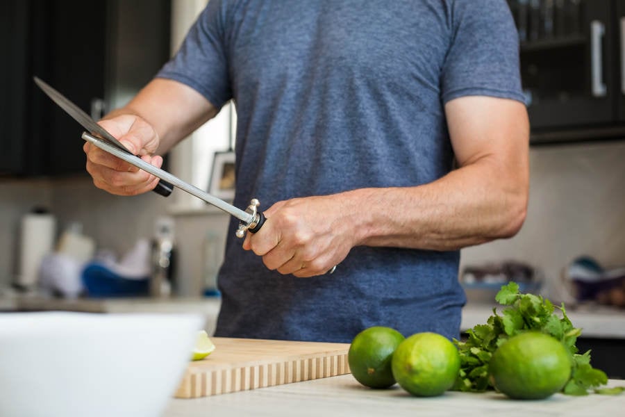  Man Sharpening a Knife in a Domestic Kitchen