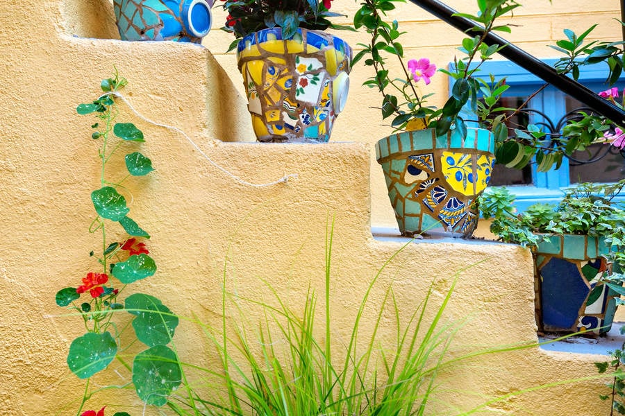 Side View of a Staircase with Colorful Planting Pots Decorated with Ceramic Pieces