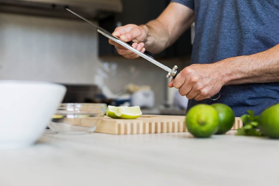  Man Sharpening a Knife in a Residential Kitchen