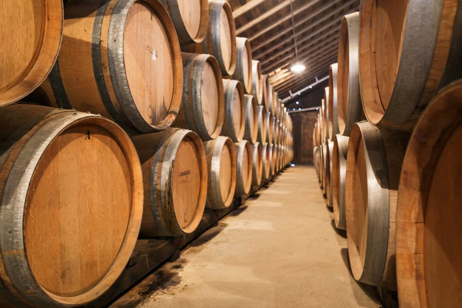 Wine Barrels Stacked in a Wine Cellar