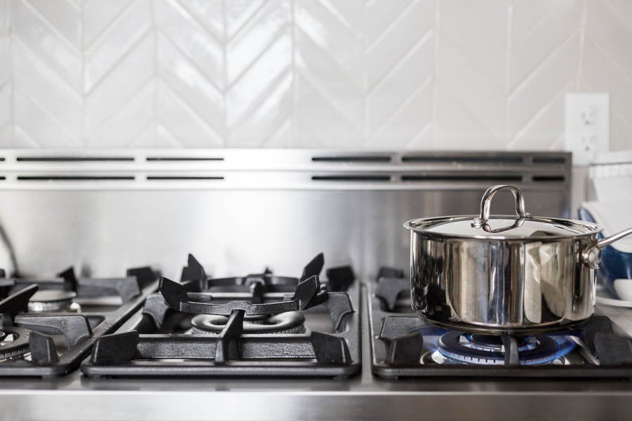 Cooking a Meal in a Stainless Steel Pot on a Gas Stove
