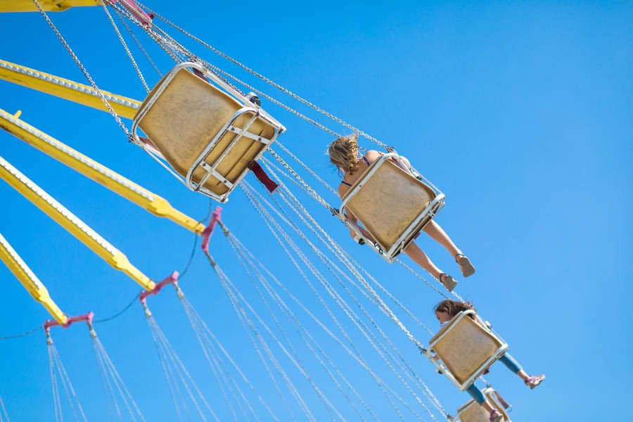 Children Riding High up on a Swing Ride at a County Fair