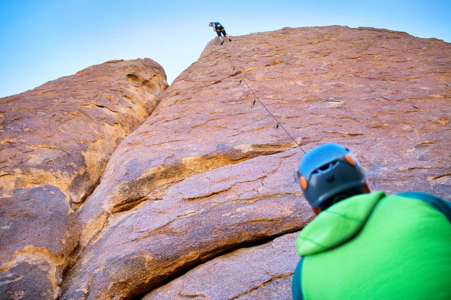 Straight up View of a Climber Belaying His Climbing Partner