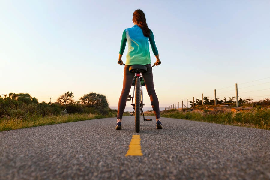 Low-Angle View of a Woman on a Cruiser Bike on a Bike Path