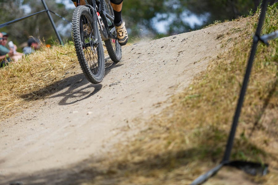Lower Section of a Mountain Biker on a Downhill Course During a Race