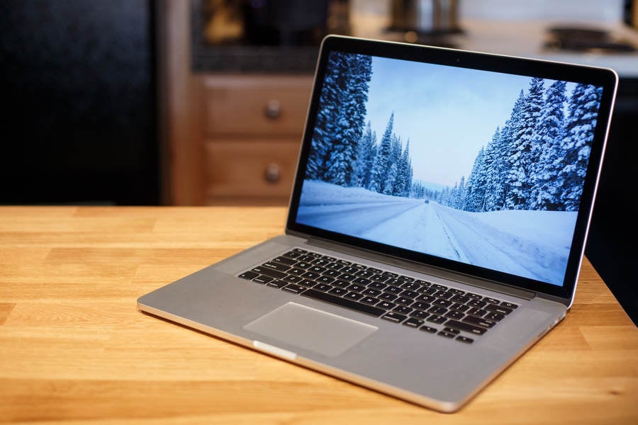 Laptop with a Picture of a Road in Winter on the Screen