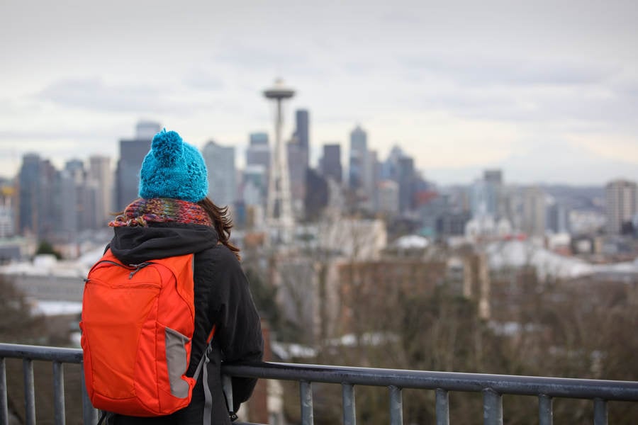 Girl with a Backpack Looking at Seattle Cityscape Before the Dusk