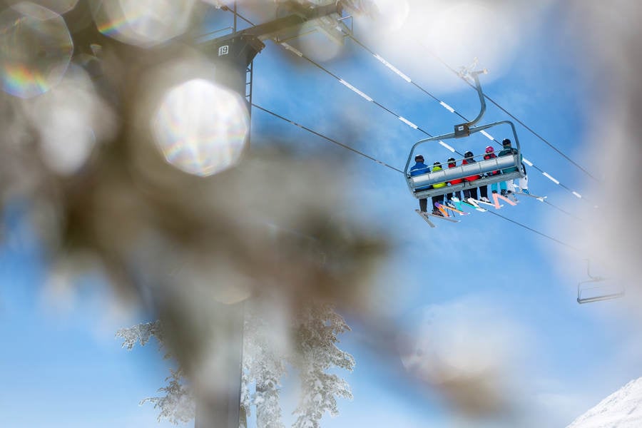 Group of Skiers Going up on a Chairlift in a Ski Resort
