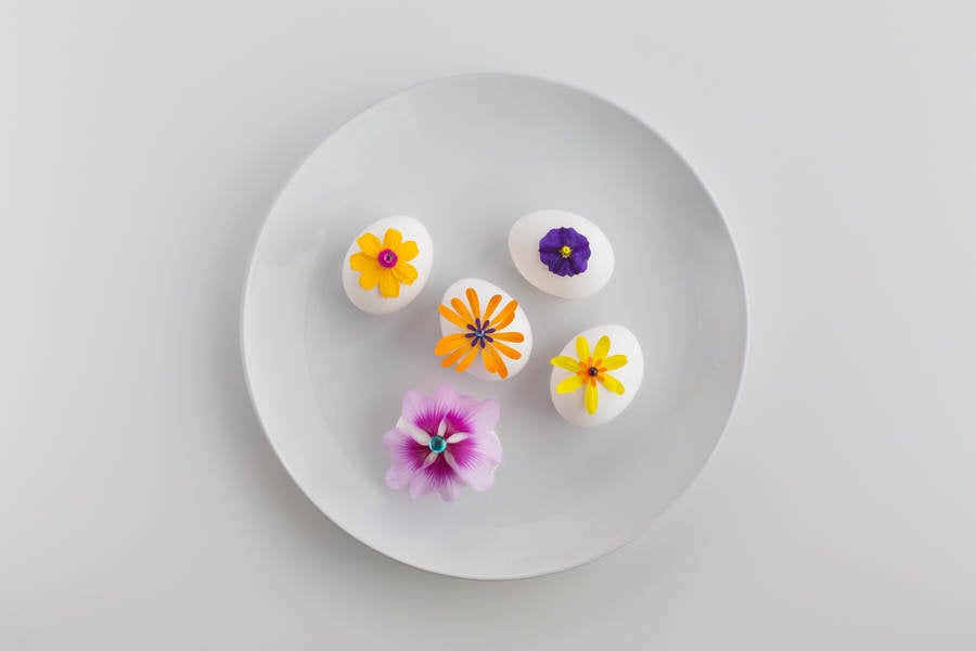 Easter Eggs with Flower Petals Arranged on a White Plate