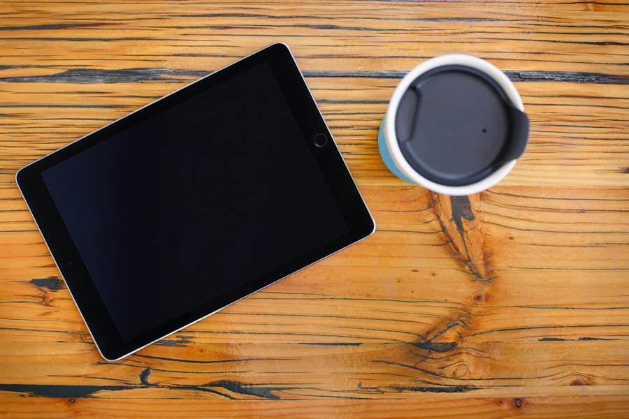 Directly from Above View of a Digital Tablet and a Coffee Mug on a Wooden Table