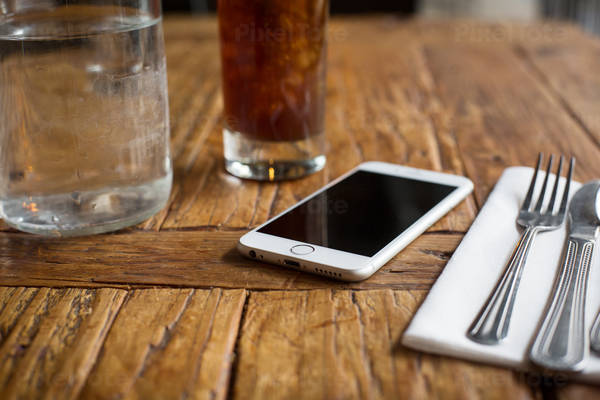 Low-Angle View of a Cell Phone on a Restaurant Table