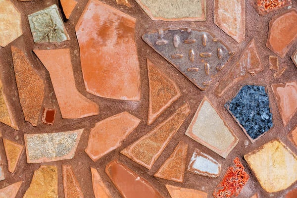 Detailed View of a Stucco Ceramic Mosaic with Diamond Pattern Metal Piece