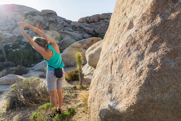 Woman Stretching Prior an Outdoor Bouldering Session