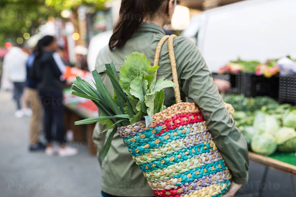 Rear View of a Woman Shopping for Fresh Vegetables at a Farmers Market