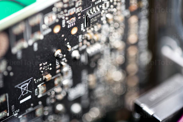 Close-Up View of a Black Circuit Board with Blurred Foreground
