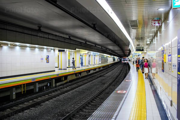 Interior of a Tokyo Subway Station with Commuters on a Train Platform