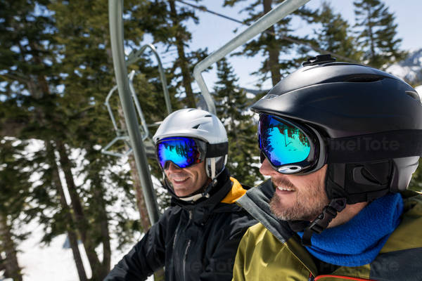 Two Skier Friends Laughing and Going up on a Ski Lift