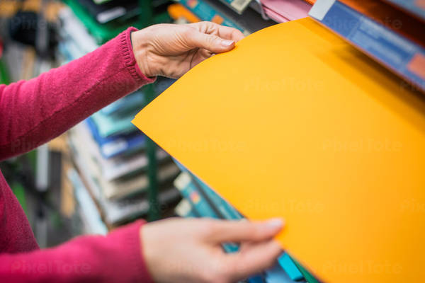 Woman Checking Color Paper in an Art Supply Store