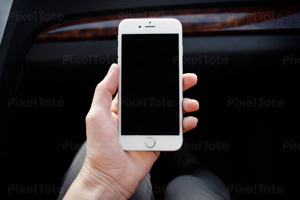 Close-Up of a Woman Holding a Cell Phone in a Car