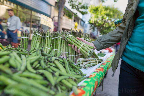 Woman Shopping for a Fresh Asparagus at a Farmers Market