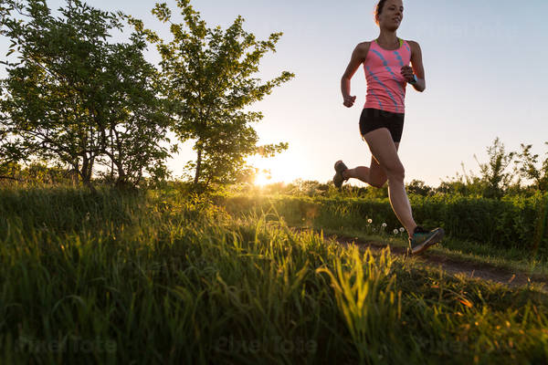 Low-Angle View of an Athletic Woman Running During Sunset