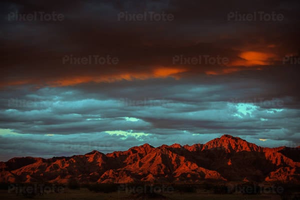 Mountains During Golden Hour with Dark Stormy Sky Above