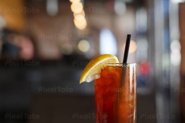 Iced Tea in a Glass with Straw and a Lemon Slice