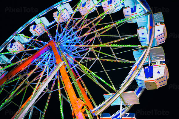 Low-Angle View of an Illuminated Ferris Wheel at Night