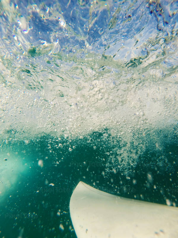 Underwater View of a Shortboard and a Passing Wave