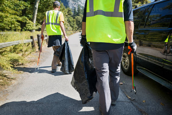 Volunteers Collecting Garbage on a Side of the Road
