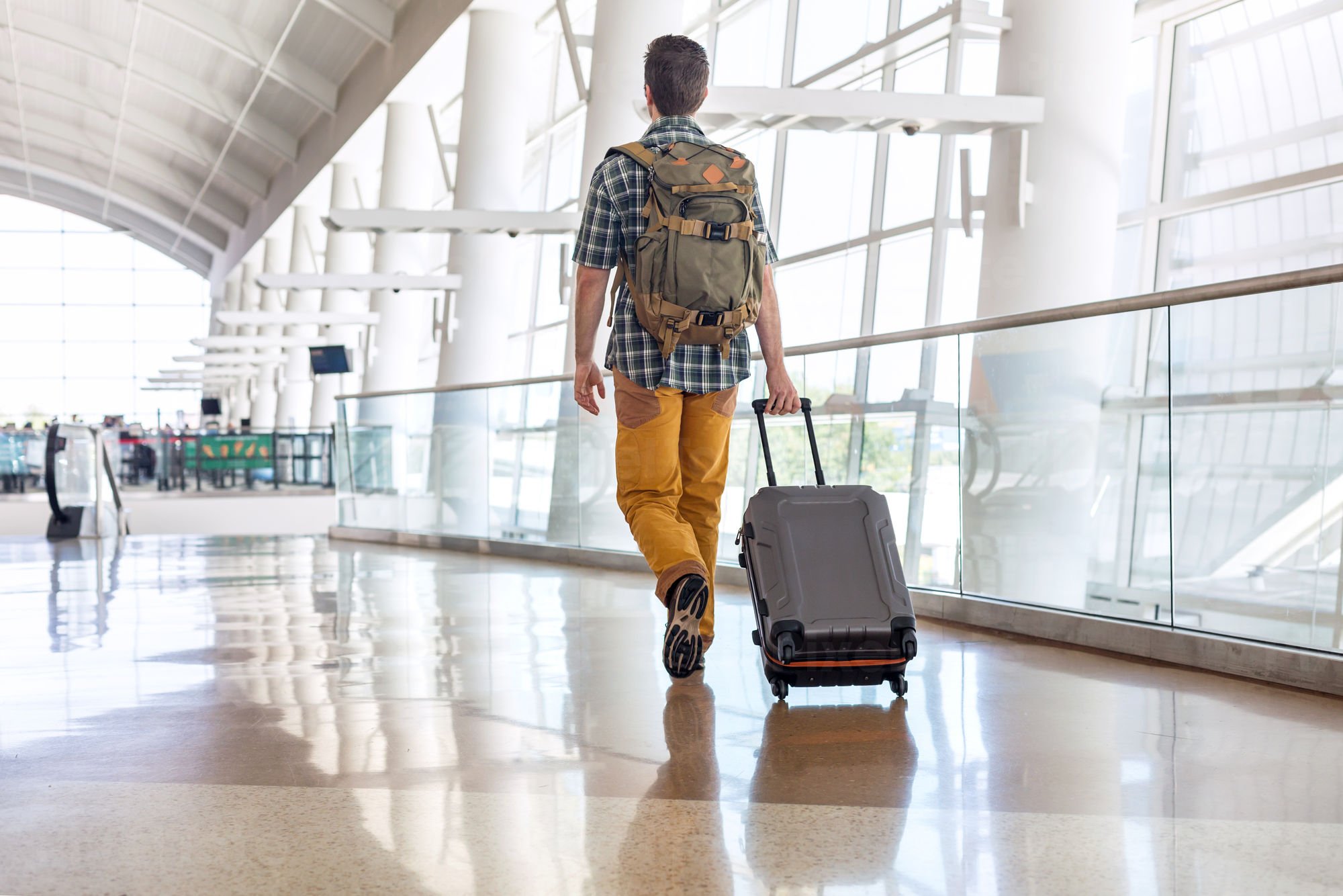 Traveler with a Backpack Pulling Stock Photo - PixelTote