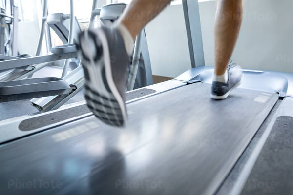 Blurred Motion of Feet of a Man Running on a Treadmill