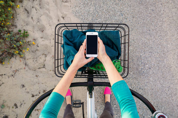 Directly-from-Above View of a Girl on a Cruiser Bike Holding a Cell Phone