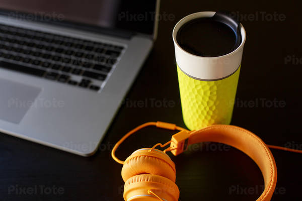 Workspace with a Laptop a Headphones and a Coffee Mug