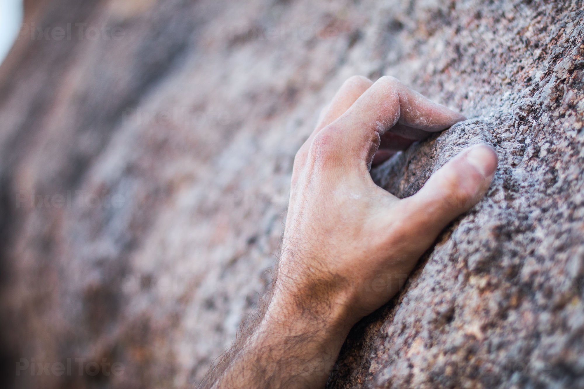 Close-Up of a Climber's Hand Crimping a Narrow Granite Hold Stock Photo