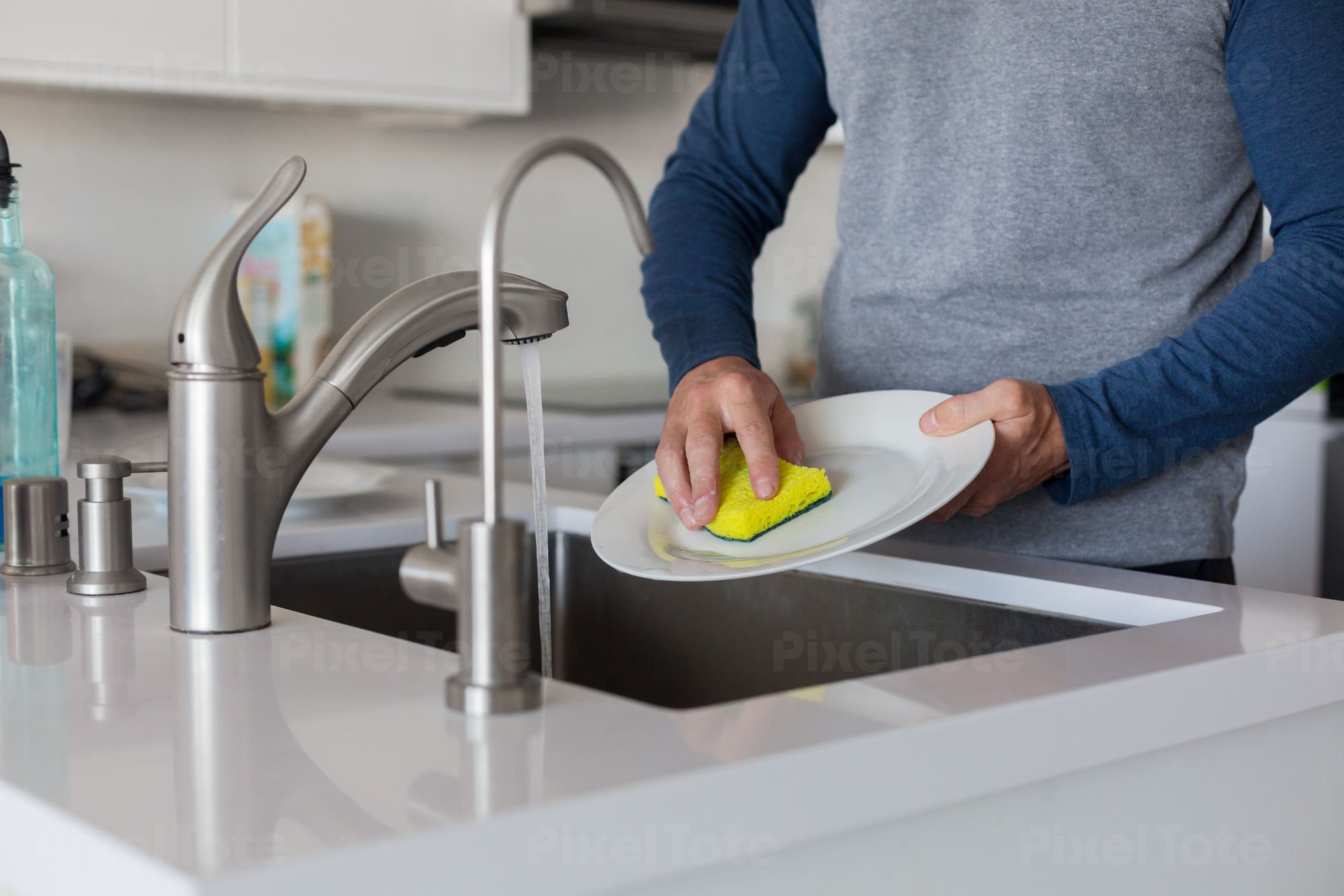 Pv Lg Man Washing Dishes In A Sink In A Modern Kitchen Default Stock Photo 